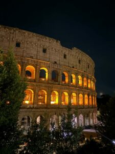 Stunning night illumination of the iconic Colosseum in Rome, Italy.