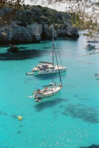 white and blue boat on sea during daytime